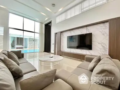 Luxurious modern living room with large windows and elegant marble wall design