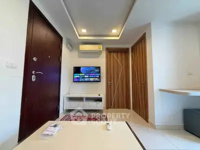 Modern living room with wall-mounted TV and stylish wooden doors