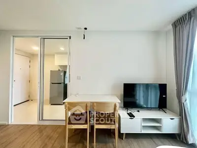 Modern living room with dining area and TV, featuring sleek furniture and natural light.
