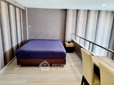 Modern bedroom with stylish decor and natural light, featuring a comfortable bed and elegant furnishings.