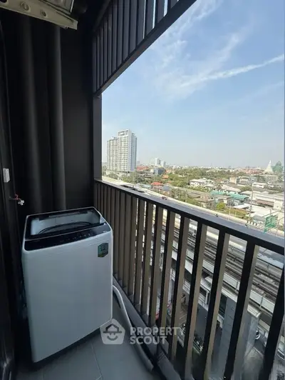 High-rise balcony with washing machine and cityscape view