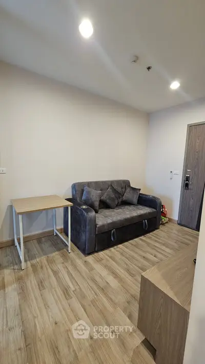 Modern living room with stylish sofa and wooden flooring