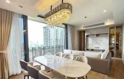 Luxurious open-plan living room with elegant chandelier and city view balcony.
