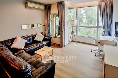 Spacious modern living room with large windows and stylish furnishings