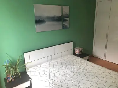 Cozy bedroom with modern decor and green accent wall