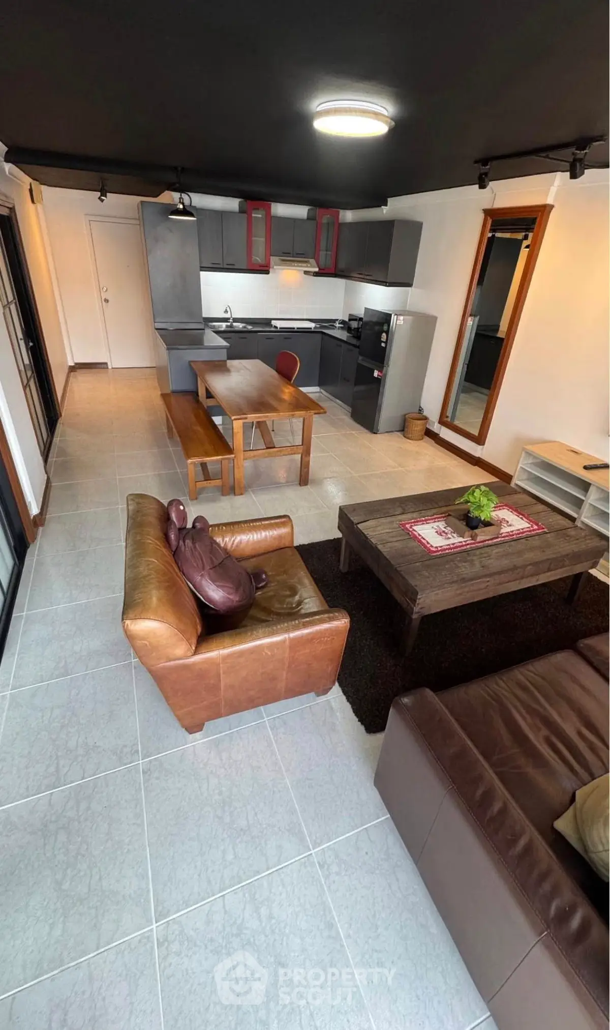 Modern open-plan living room with stylish kitchen and cozy seating area.