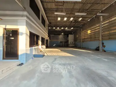 Spacious industrial warehouse with high ceilings and ample natural light.