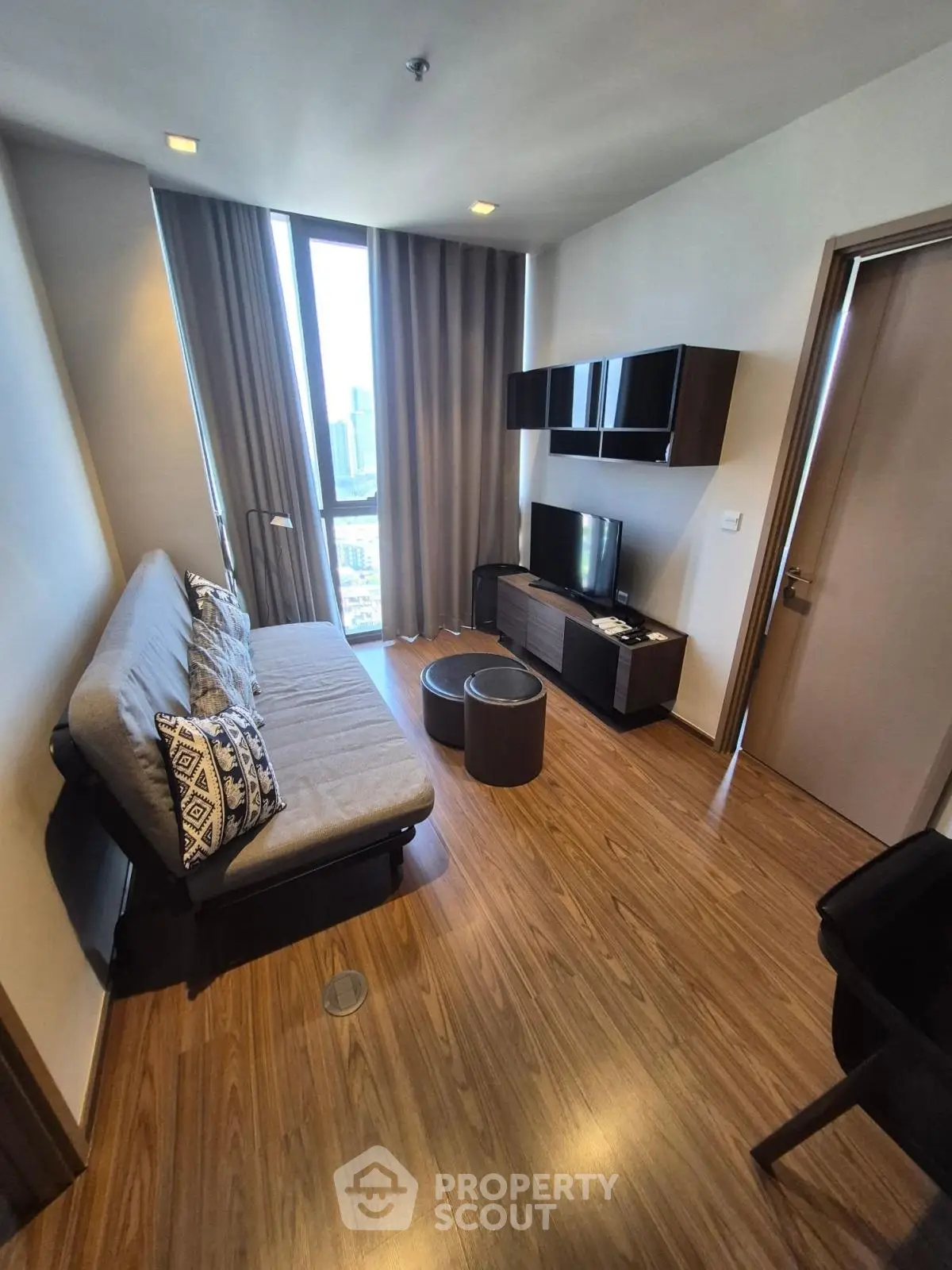 Modern living room with sleek furniture and city view, perfect for urban living.