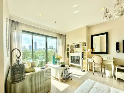 Bright and elegant living room with city view, featuring stylish decor and large windows.
