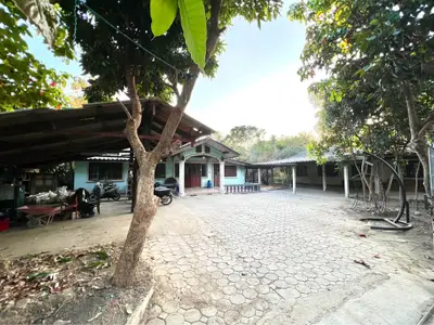 Charming rural property with spacious courtyard and lush greenery, perfect for serene living.