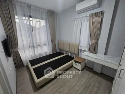 Modern bedroom with large window, air conditioning, and minimalist decor.