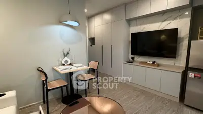 Modern living room with sleek cabinetry and dining area in stylish apartment.