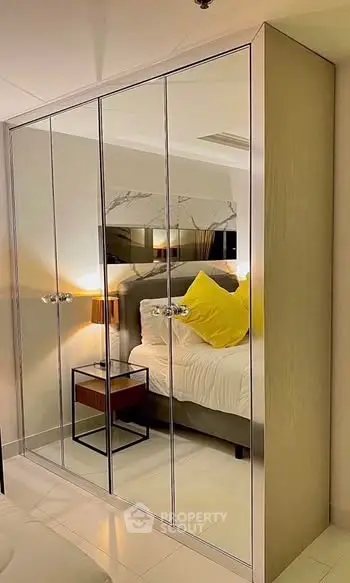 Elegant bedroom with mirrored wardrobe and cozy lighting