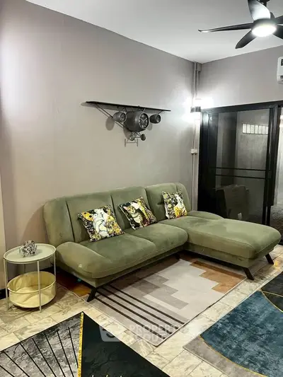 Stylish living room with modern green sofa and unique wall decor