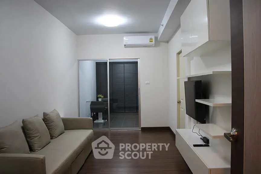 Modern living room with sleek furniture and air conditioning, perfect for cozy relaxation.