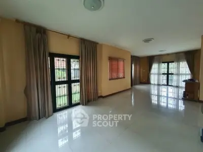 Spacious empty living room with large windows and natural light