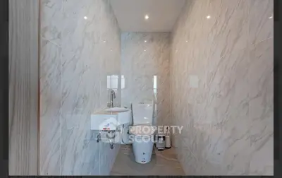 Modern bathroom with marble walls and sleek fixtures