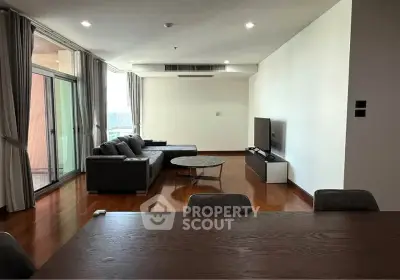 Spacious modern living room with large windows and elegant furnishings