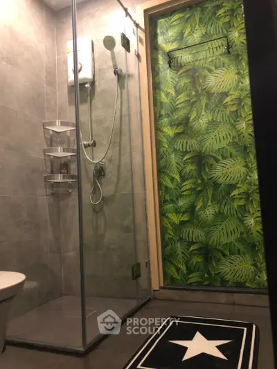 Modern bathroom with glass shower and tropical leaf wallpaper