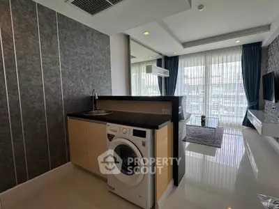 Modern living room with washing machine and stylish decor in a bright apartment.