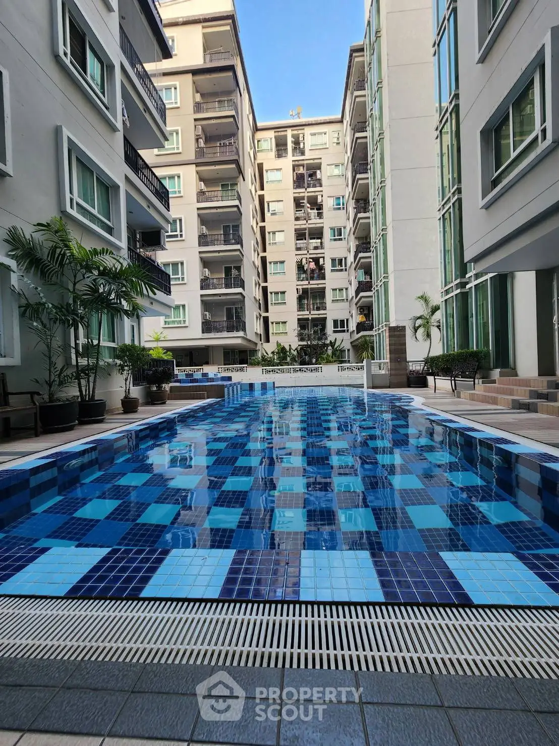 Luxurious apartment complex with stunning outdoor pool and modern architecture