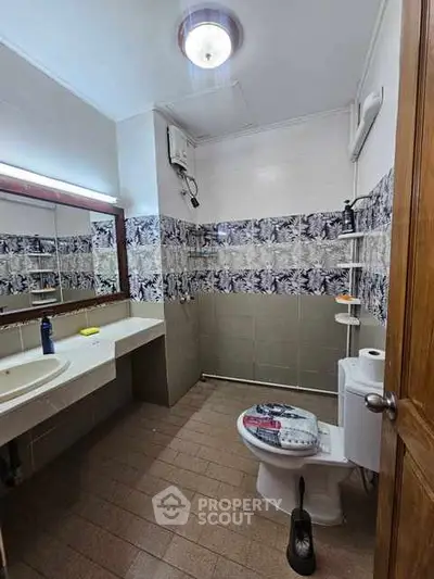 Spacious bathroom with modern fixtures and stylish tile design.