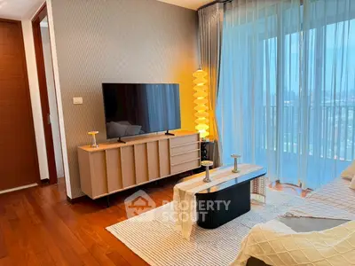 Modern living room with city view, stylish furniture, and large TV