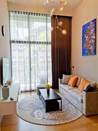 Modern living room with high ceilings and stylish decor in a luxury apartment.