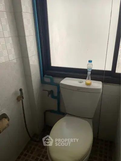 Compact bathroom with frosted window and basic fixtures