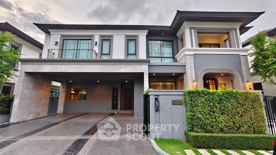 Luxurious modern two-story house with elegant facade and spacious driveway in upscale neighborhood.