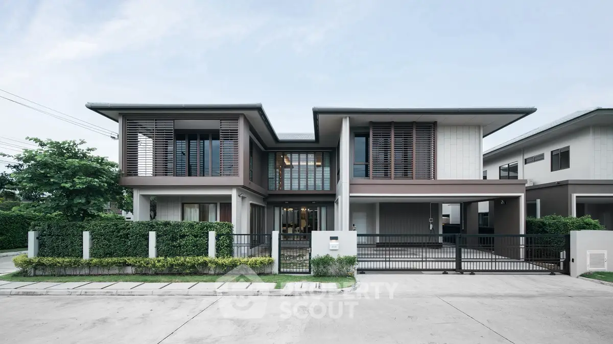 Modern two-story house with sleek design and lush greenery, perfect for contemporary living.