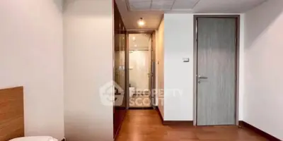 Spacious bedroom with wooden flooring and modern design