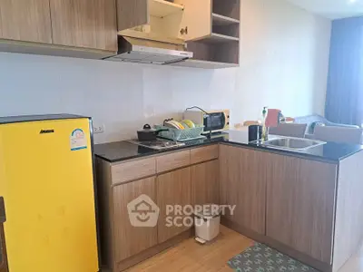 Modern kitchen with yellow fridge and open layout in cozy apartment