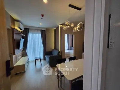 Modern living room with stylish lighting and open layout, perfect for urban living.