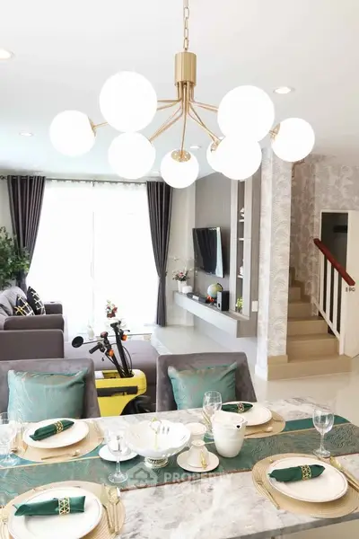 Elegant dining area with modern chandelier and open living room view