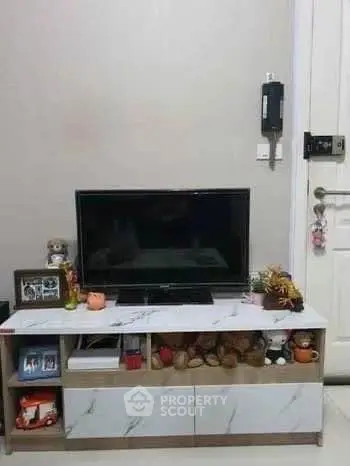 Cozy living room with modern TV stand and decorative items, perfect for relaxation and entertainment.