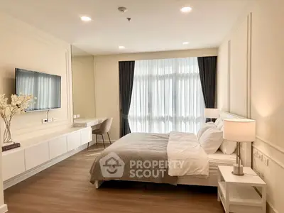 Spacious modern bedroom with elegant decor and natural light