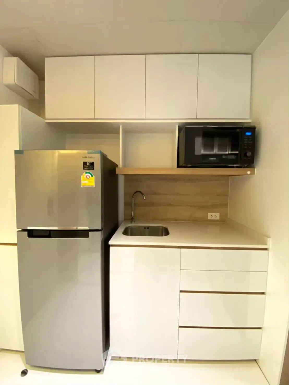 Modern compact kitchen with sleek cabinets and stainless steel appliances