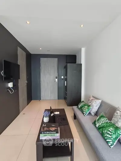 Modern living room with sleek design, featuring a cozy sofa, wall-mounted TV, and stylish decor.