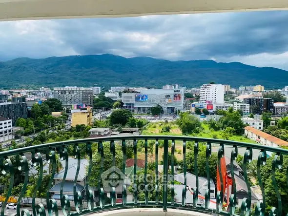 Stunning balcony view overlooking cityscape and mountains, perfect for urban living with a touch of nature.