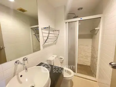 Modern bathroom with sleek fixtures and glass shower enclosure