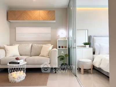 Modern living room with cozy sofa and stylish decor adjacent to a serene bedroom.