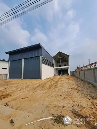 Modern industrial warehouse with spacious exterior and large entry doors