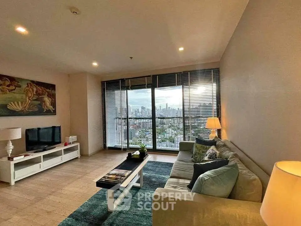 Spacious living room with stunning city view, modern decor, and ample natural light.