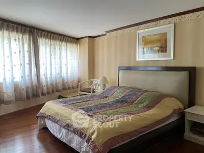 Spacious bedroom with elegant decor and large windows for natural light