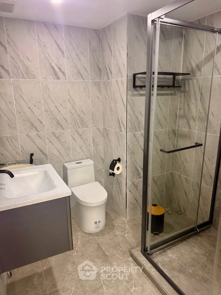Modern bathroom with sleek shower and elegant tile design