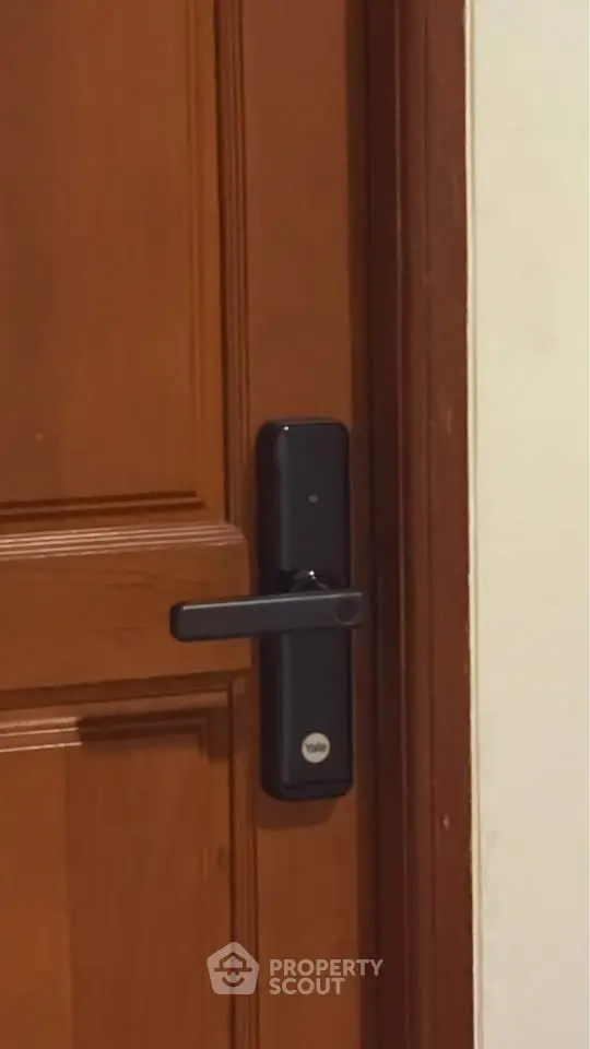 Modern wooden door with sleek digital lock for enhanced security.