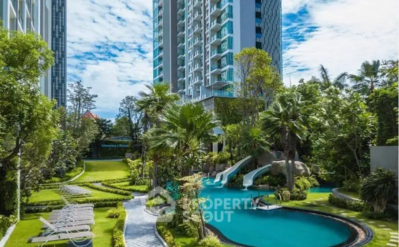 Luxurious residential building with lush garden and inviting pool area.