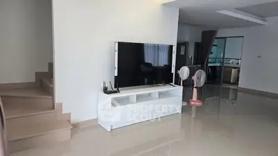 Spacious modern living room with sleek TV stand and glossy floors