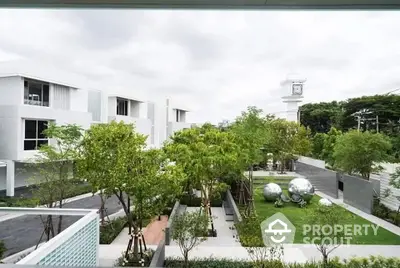 Modern residential complex with lush green gardens and contemporary architecture.